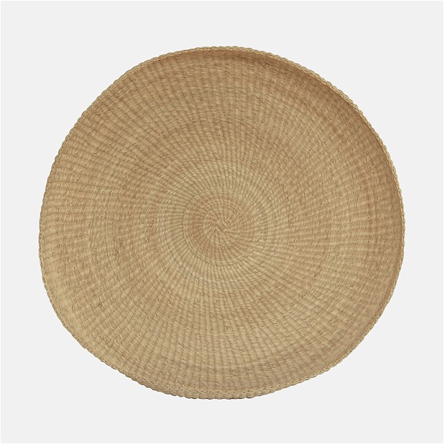a round woven placemat on a white background