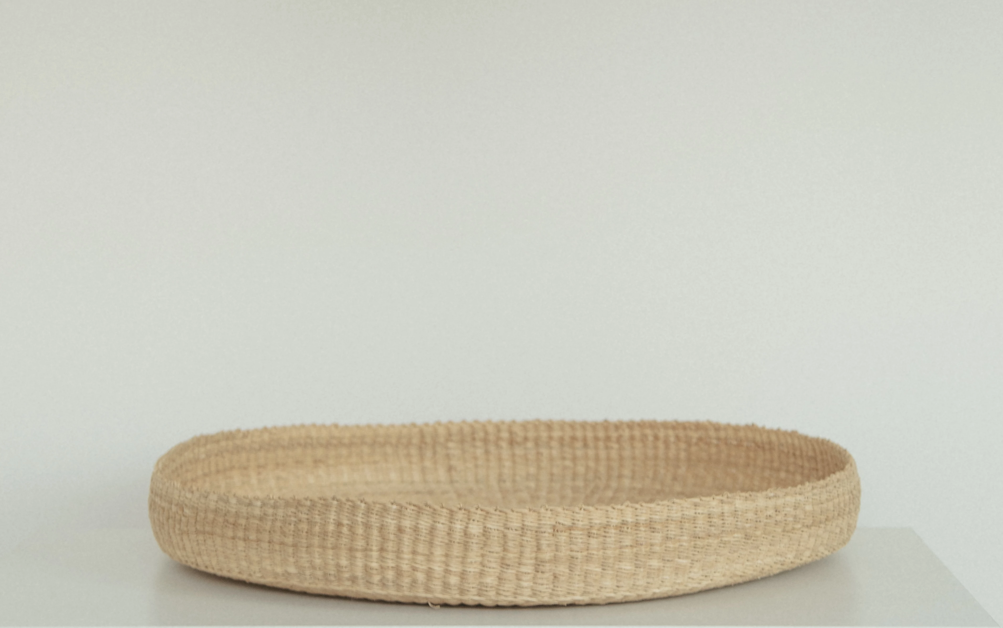a woven basket sitting on top of a table
