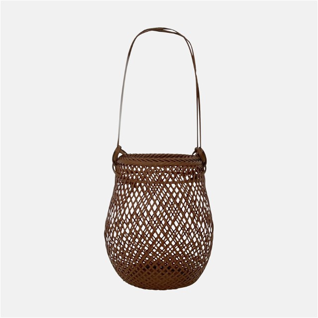 a brown woven bag on a white background