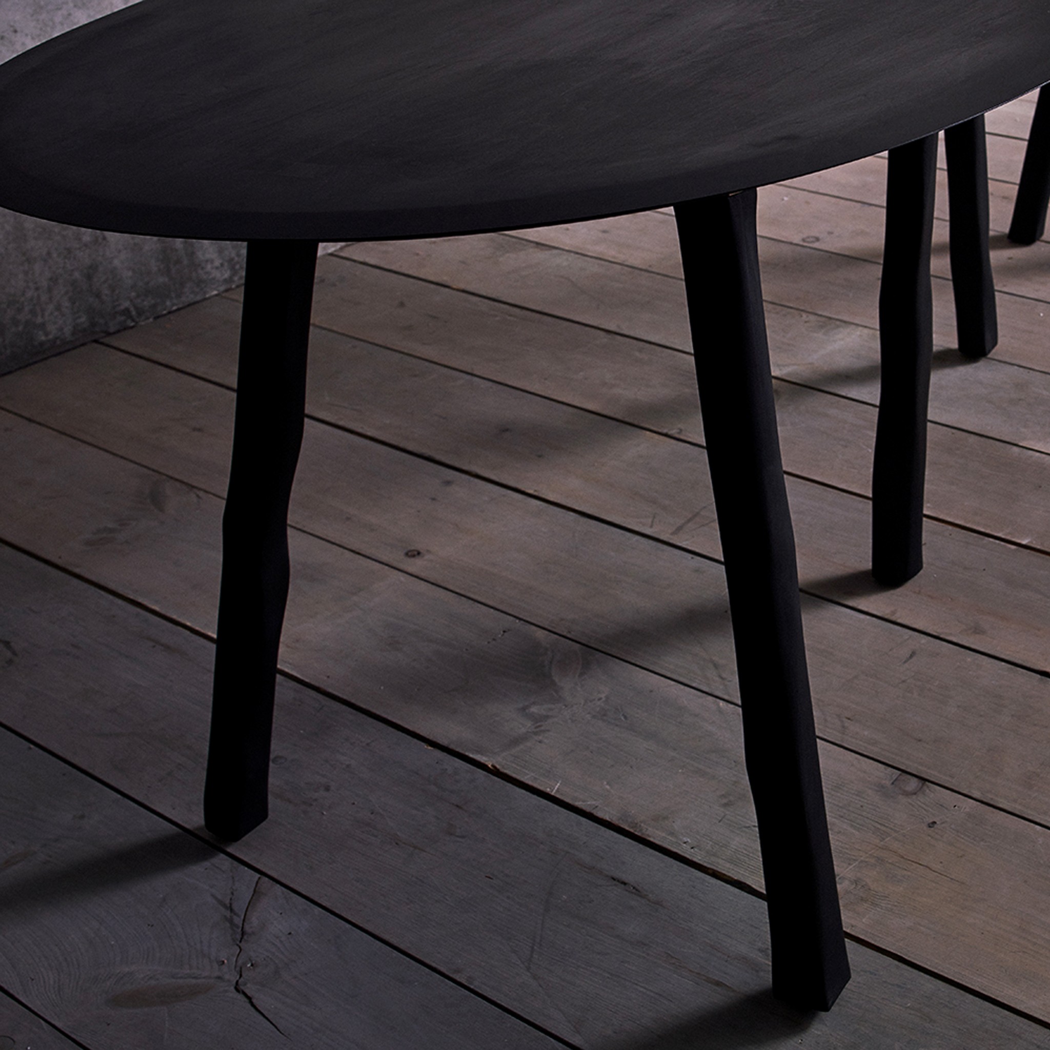 a black table sitting on top of a wooden floor