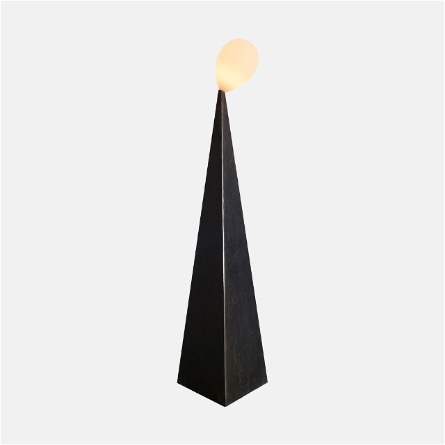 a tall black object with a light on top of it