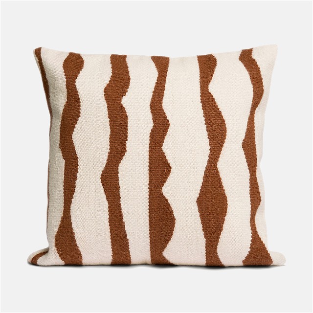 a brown and white striped pillow on a white background