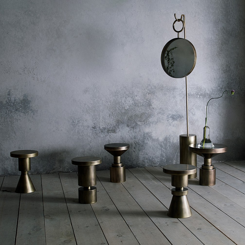 a group of stools and mirrors on a wooden floor