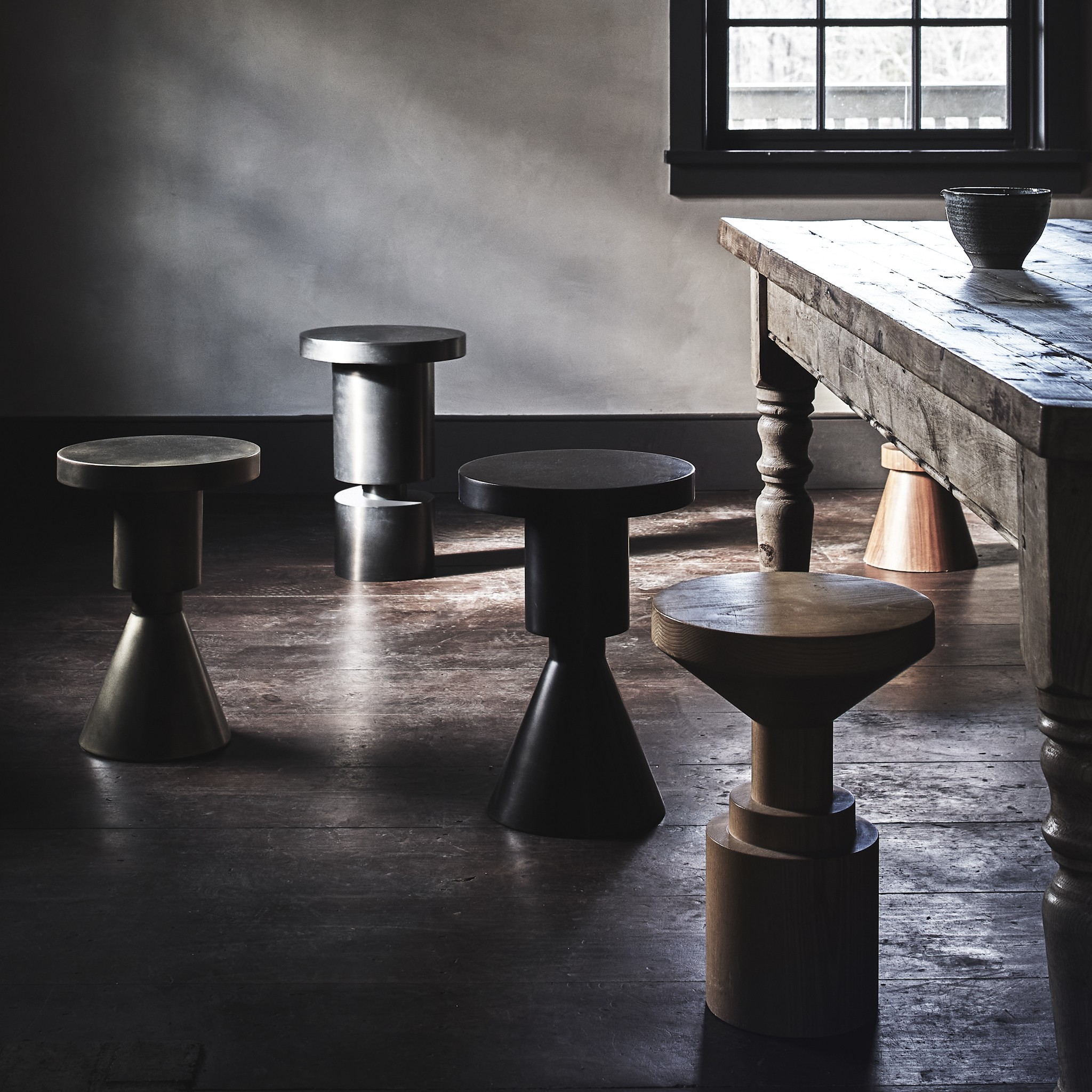 a group of tables and stools in a room