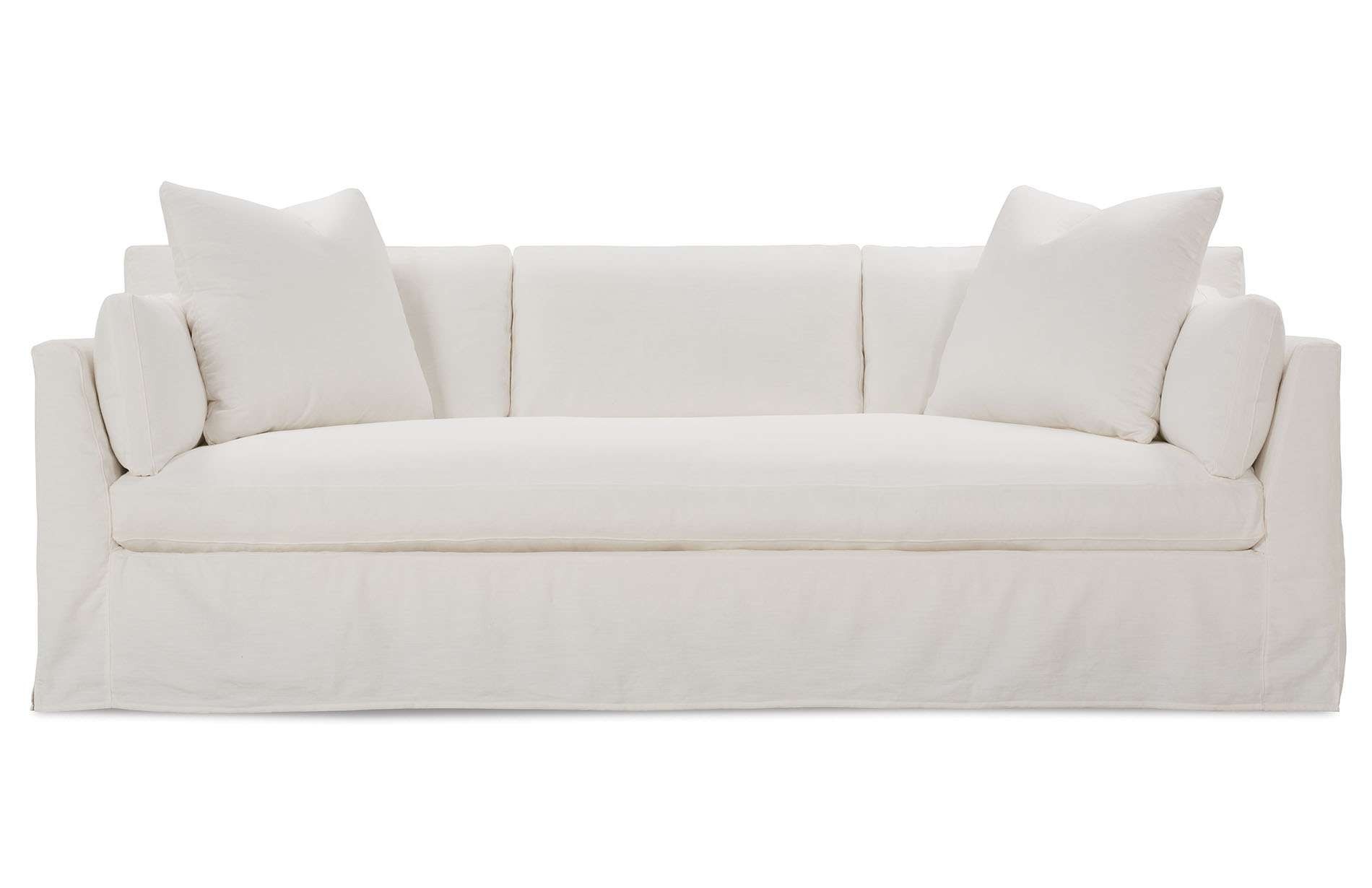 a white couch with pillows on top of it