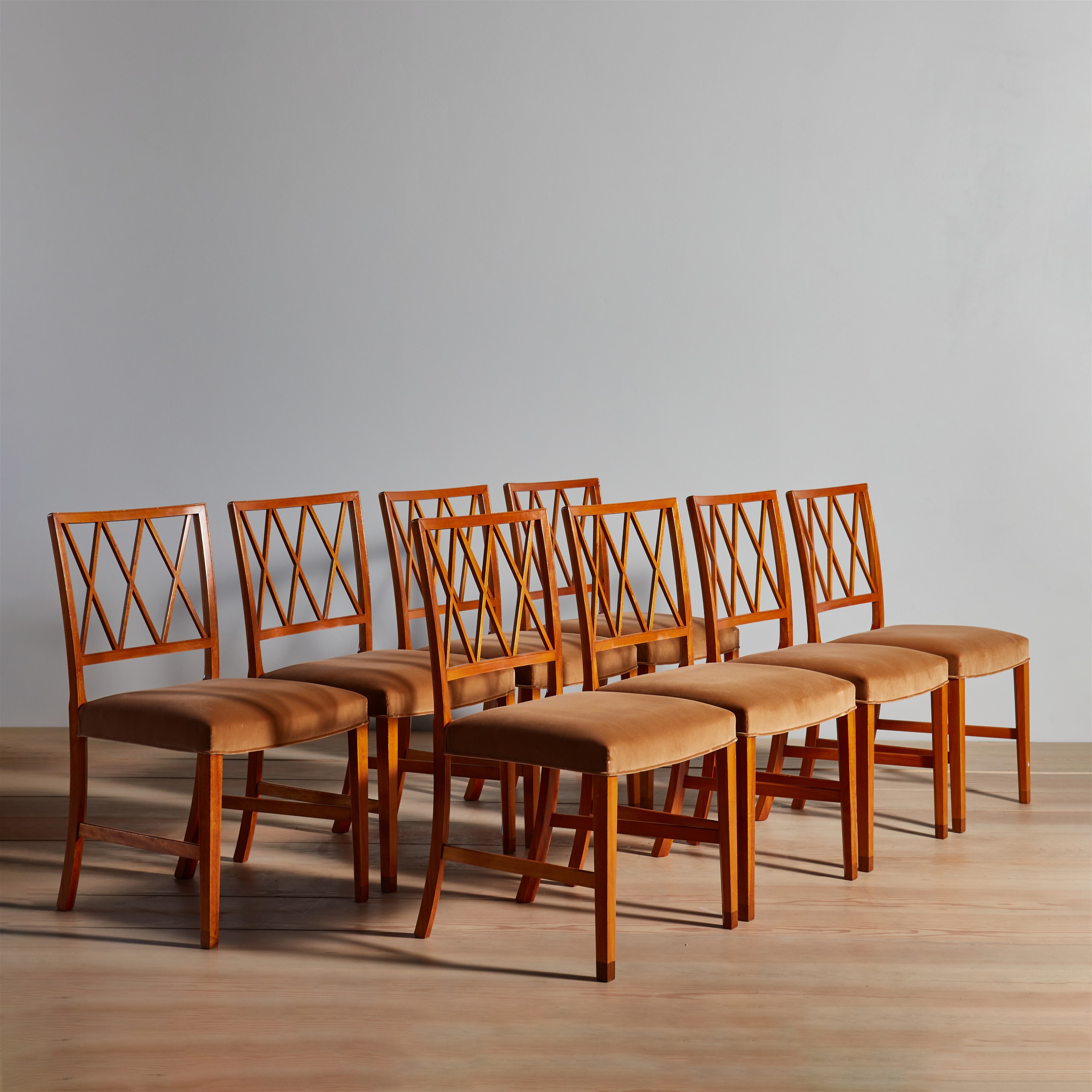 a set of six wooden chairs sitting on top of a wooden floor