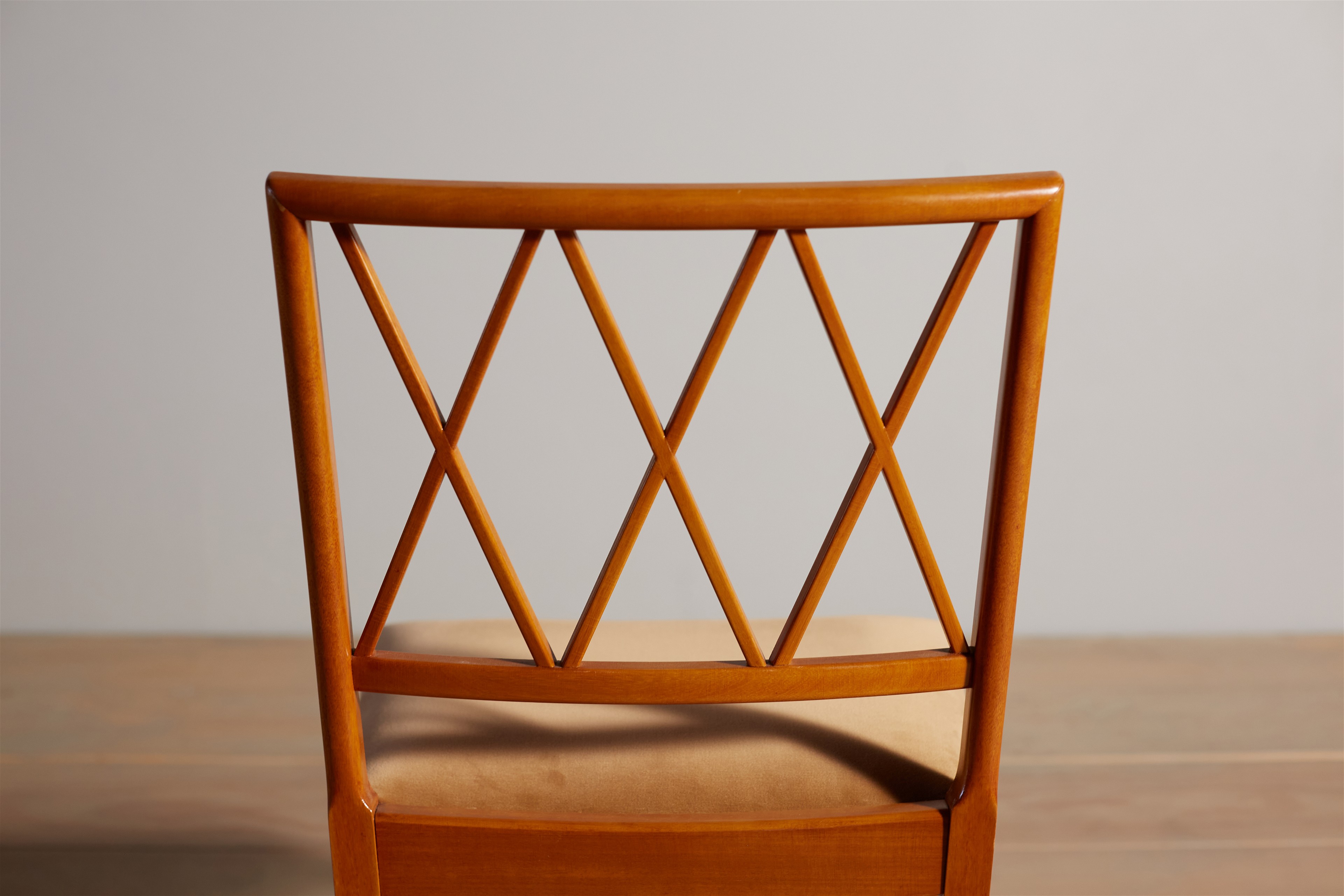 a close up of a wooden chair on a table