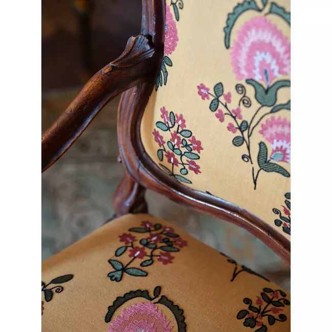 a close up of a chair with a floral pattern
