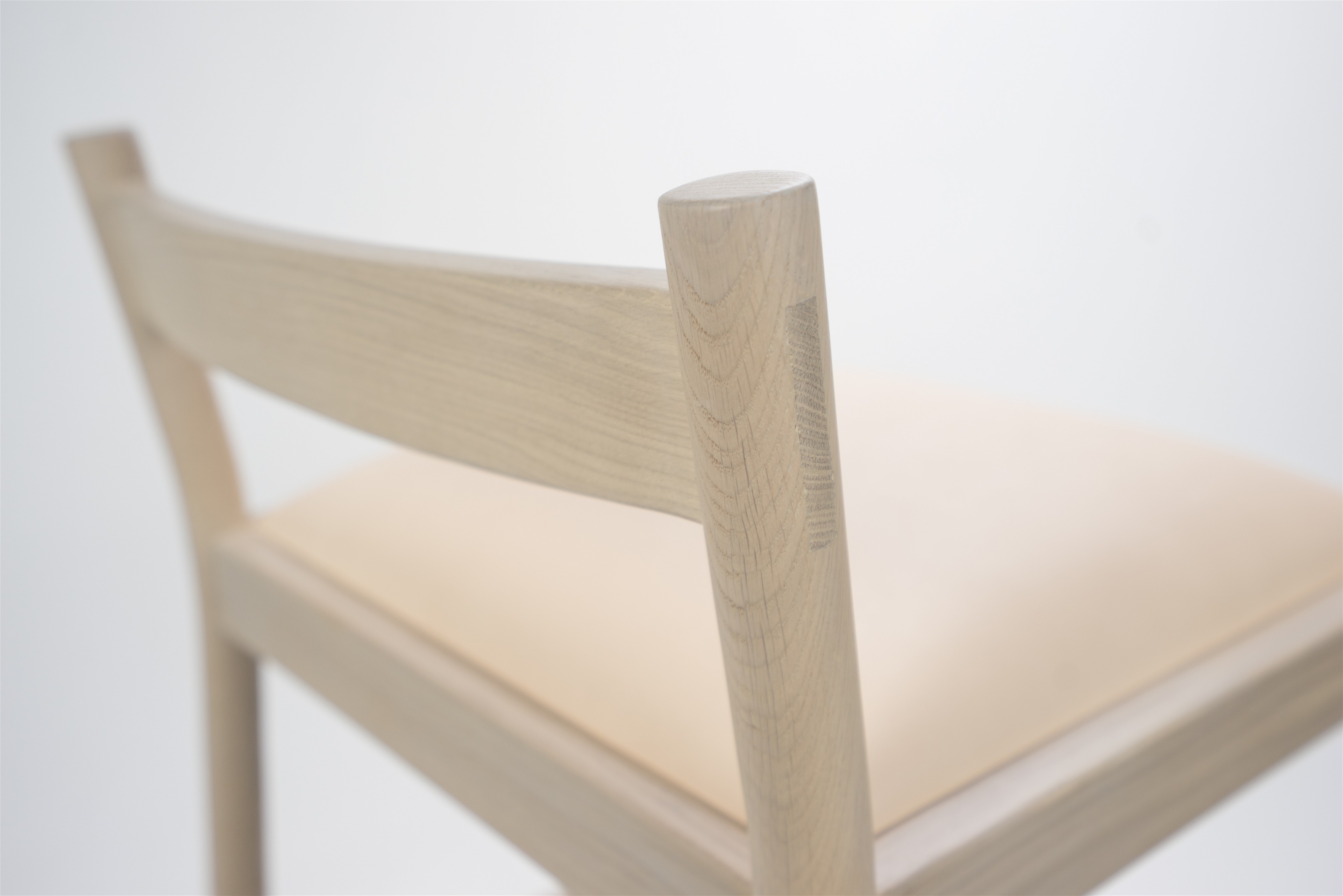 a close up of a wooden chair with a white background