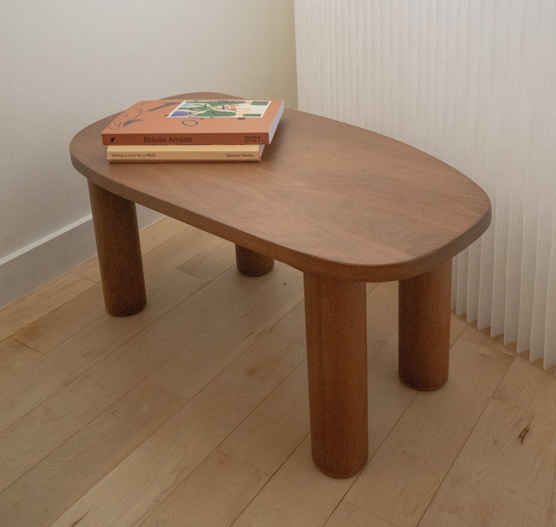 a wooden table with two books on top of it
