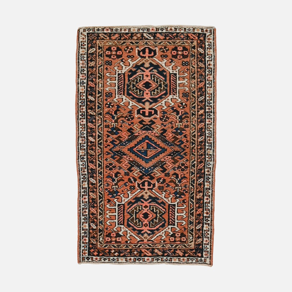 an orange and black rug on a white background
