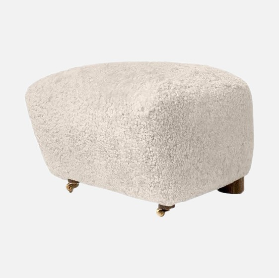 a white foot stool with wheels on it