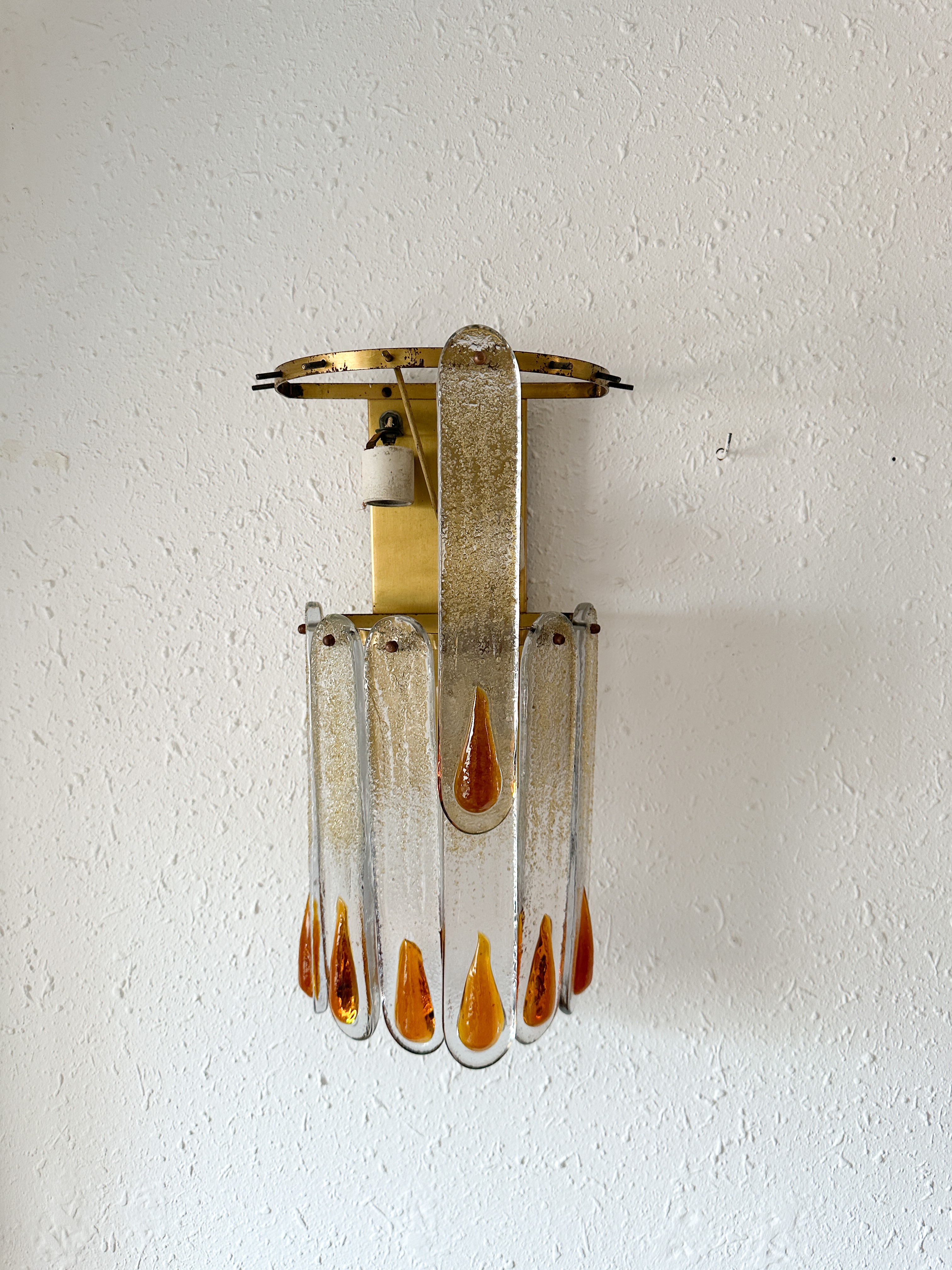 a wall mounted light fixture on a white wall