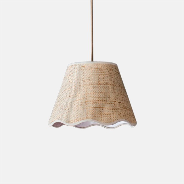 a beige lamp shade hanging from a ceiling