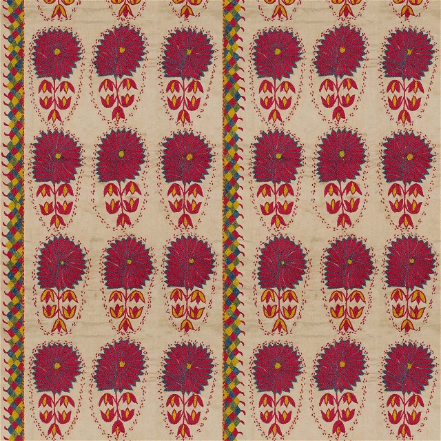 a red and yellow floral design on a beige background