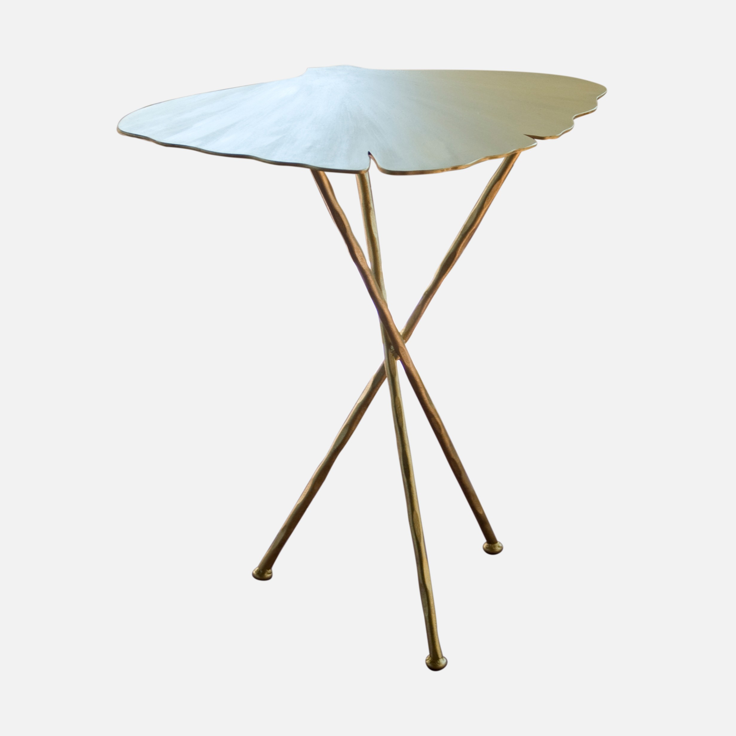 a metal table with a leaf shaped top