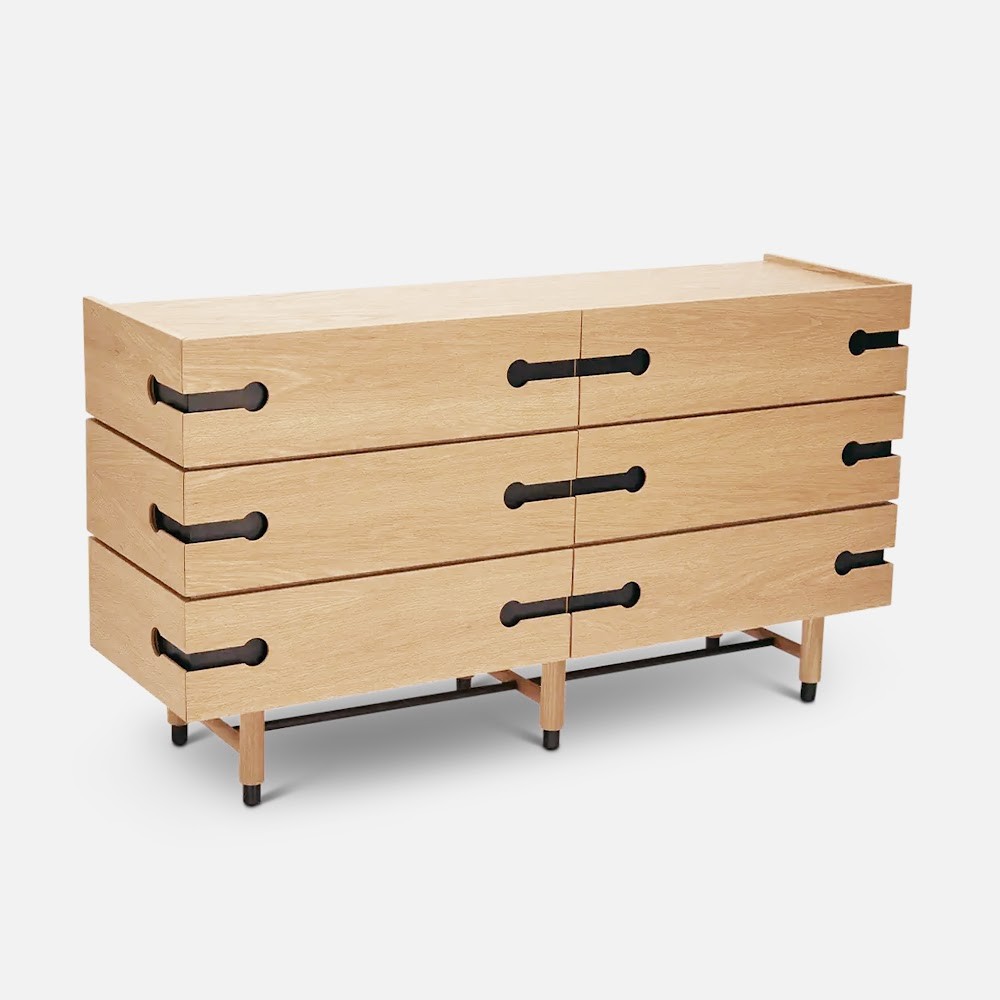 a wooden dresser with black handles and drawers