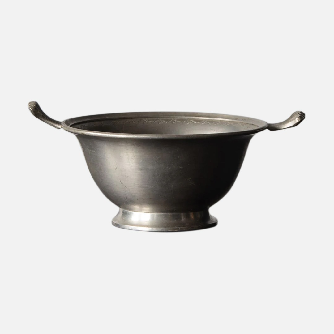a metal bowl with a spoon in it