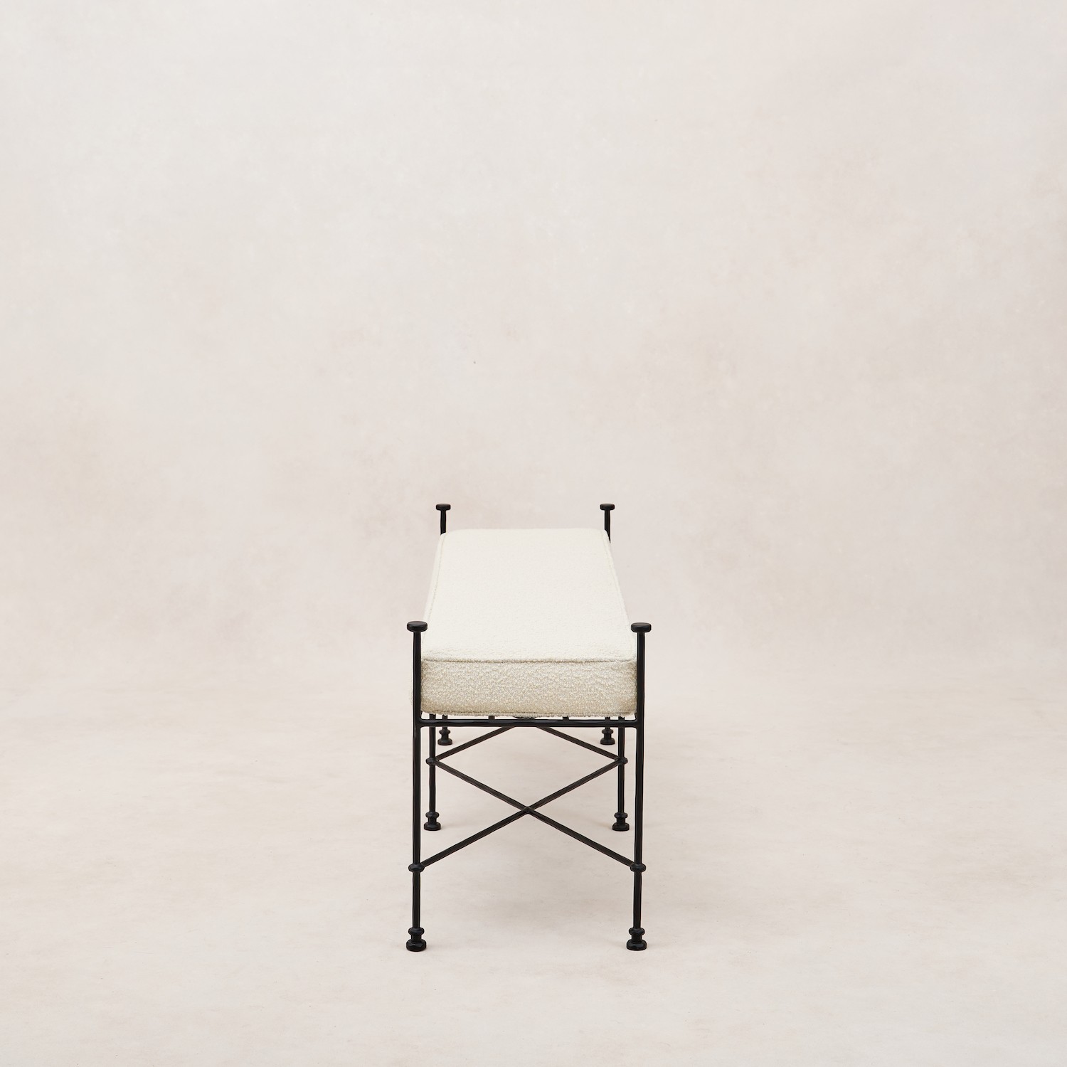 a white chair with black legs and a white cushion