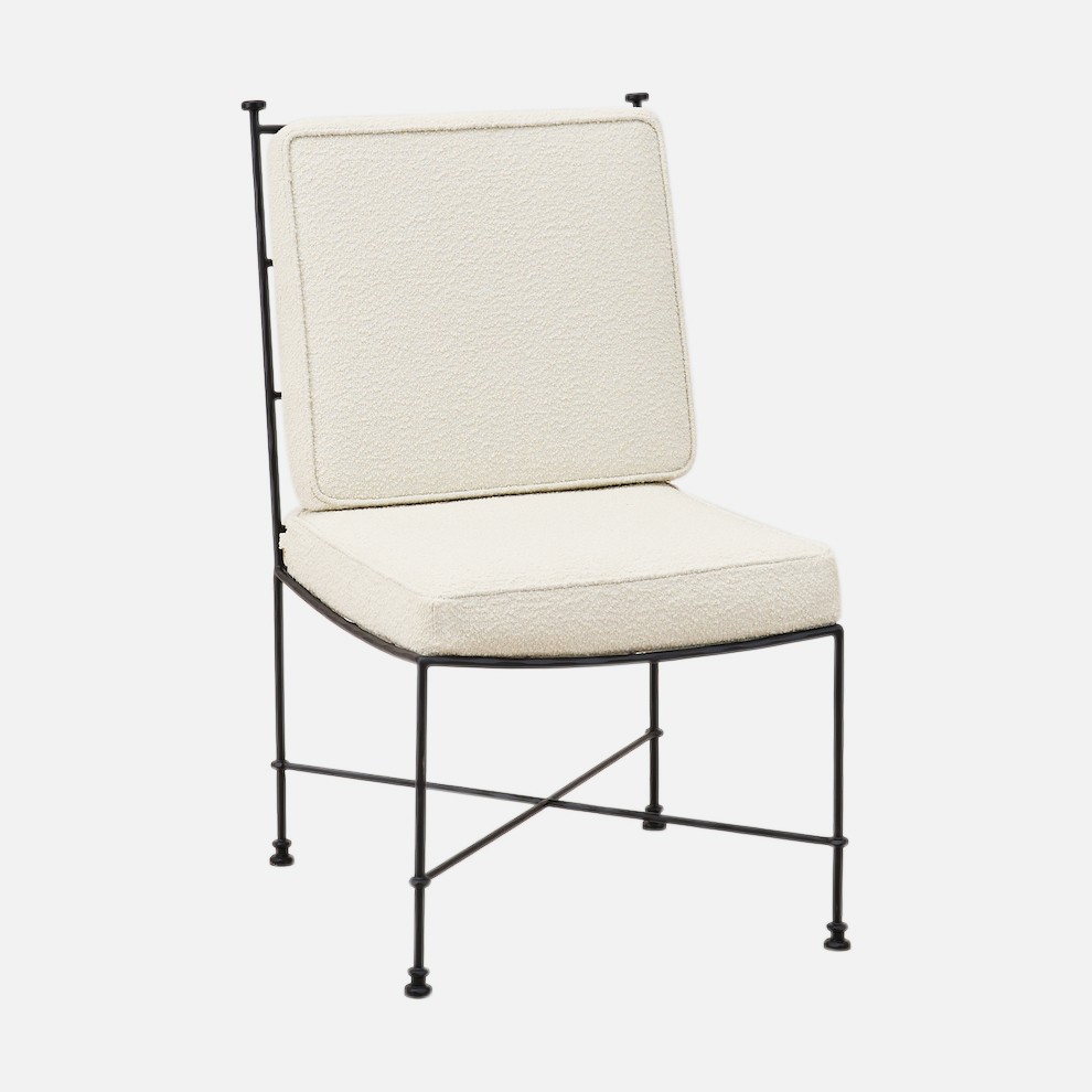 a white chair with a black frame and a white cushion