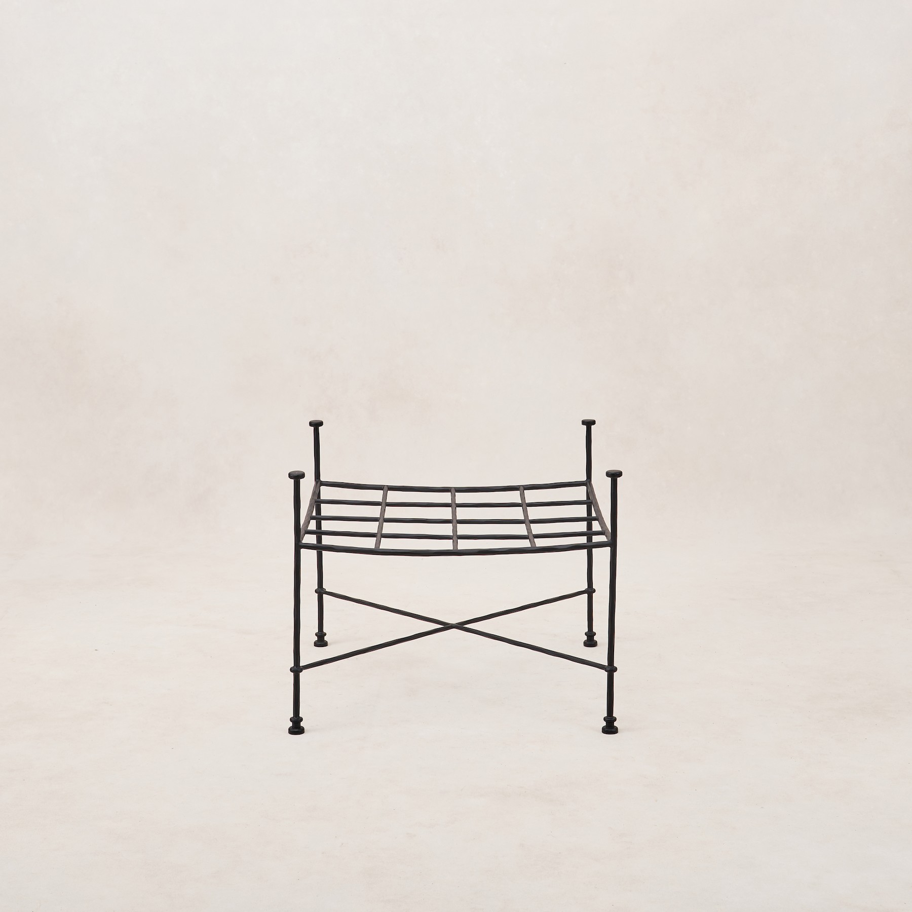 a black iron bed frame with a white background