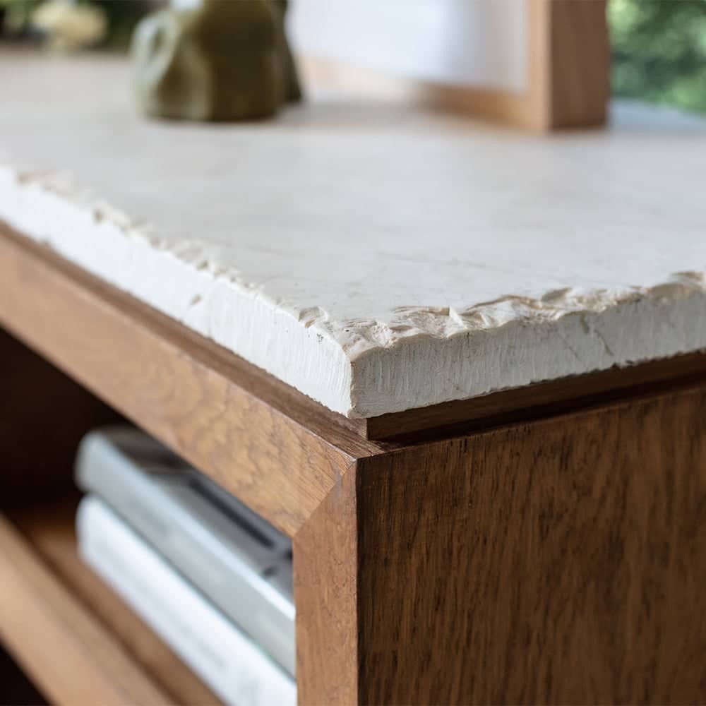 a close up of a wooden table with a white counter top