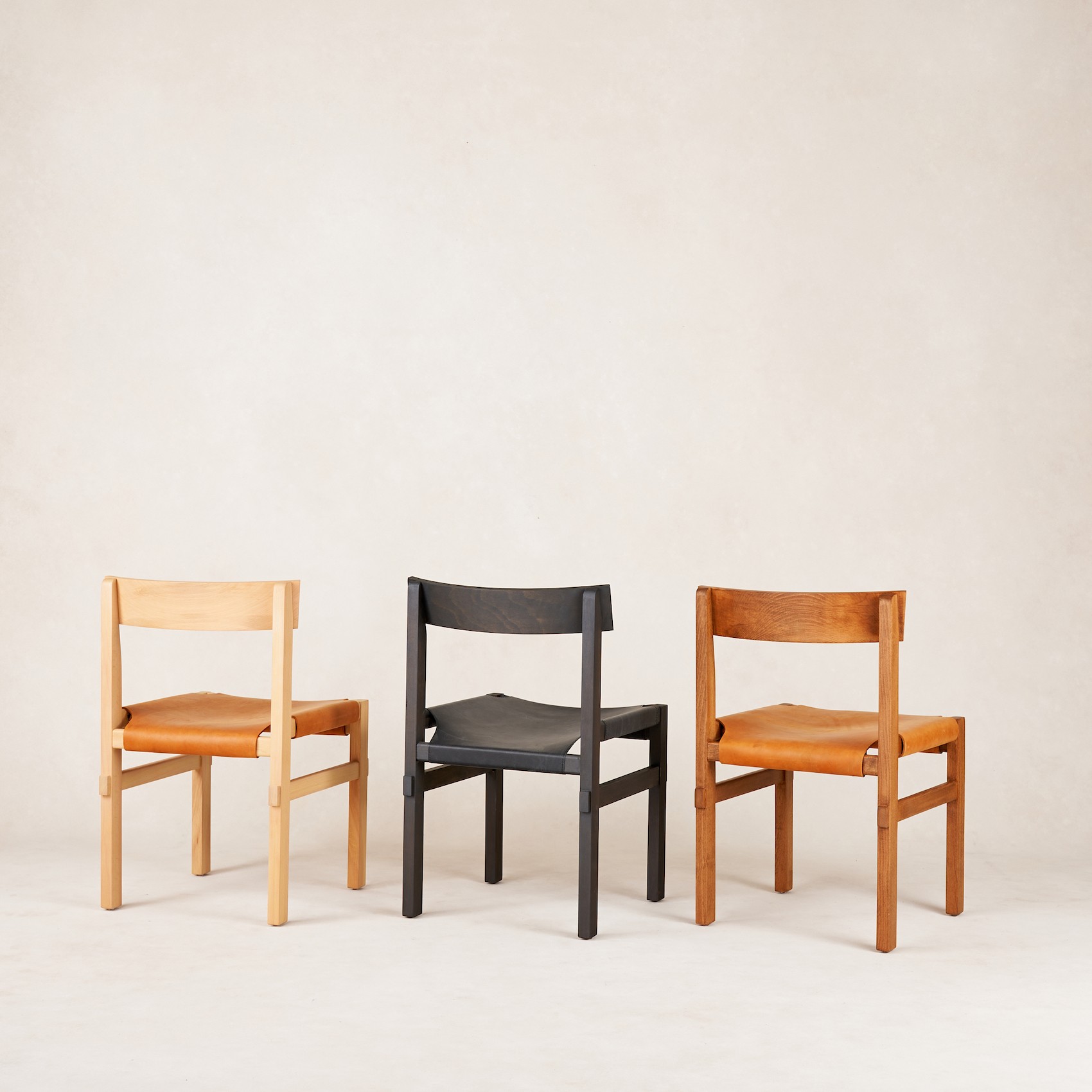 a group of three chairs sitting next to each other