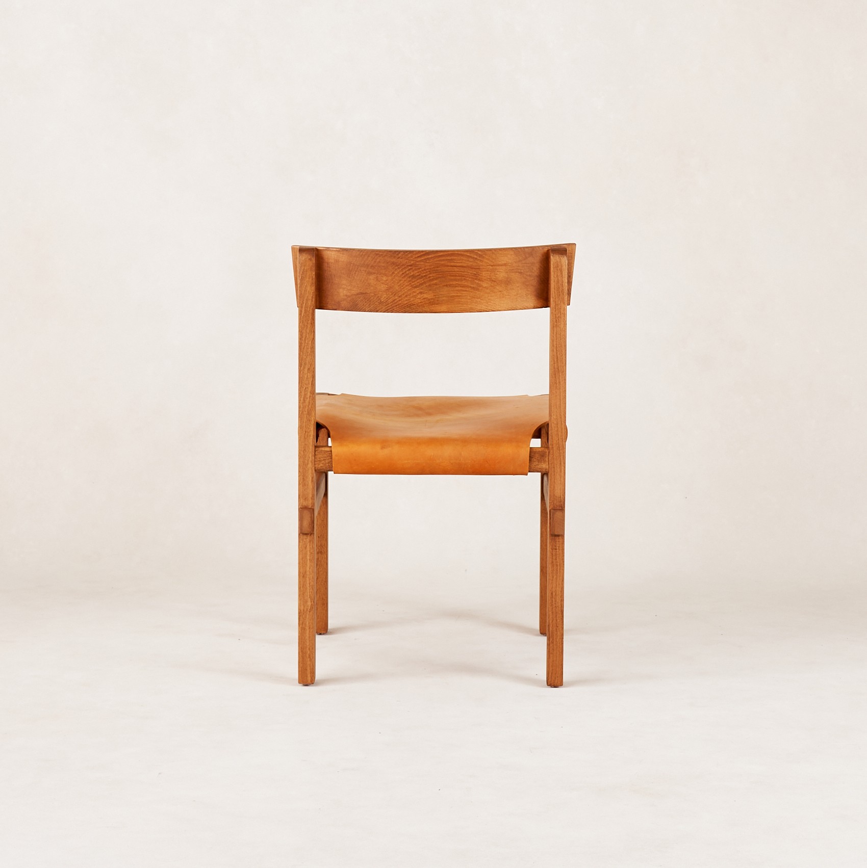 a wooden chair sitting on top of a white floor