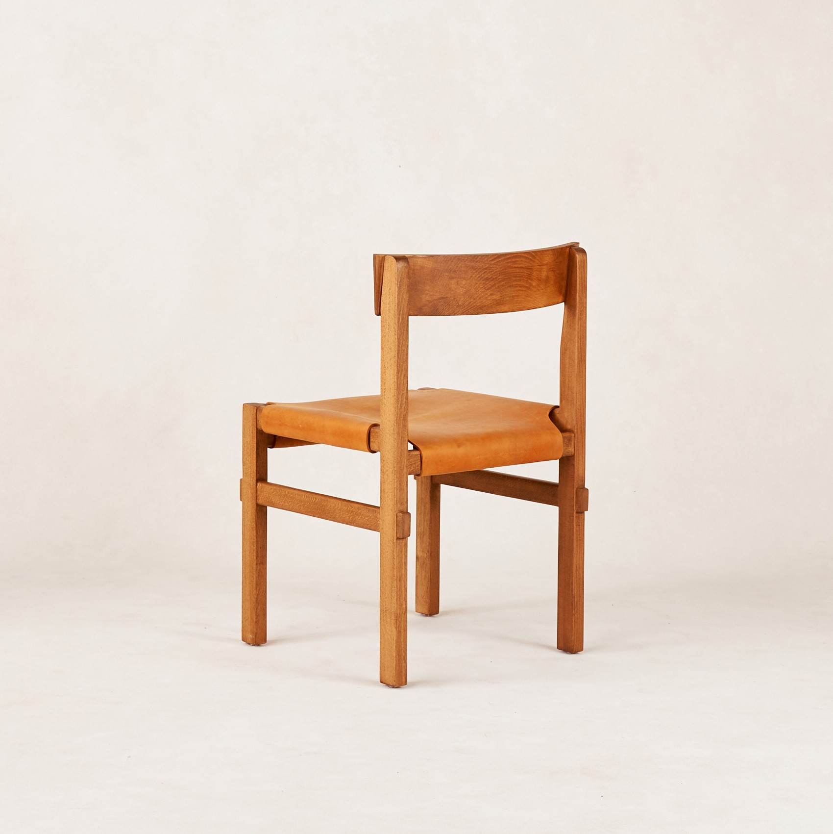 a wooden chair sitting on top of a white floor