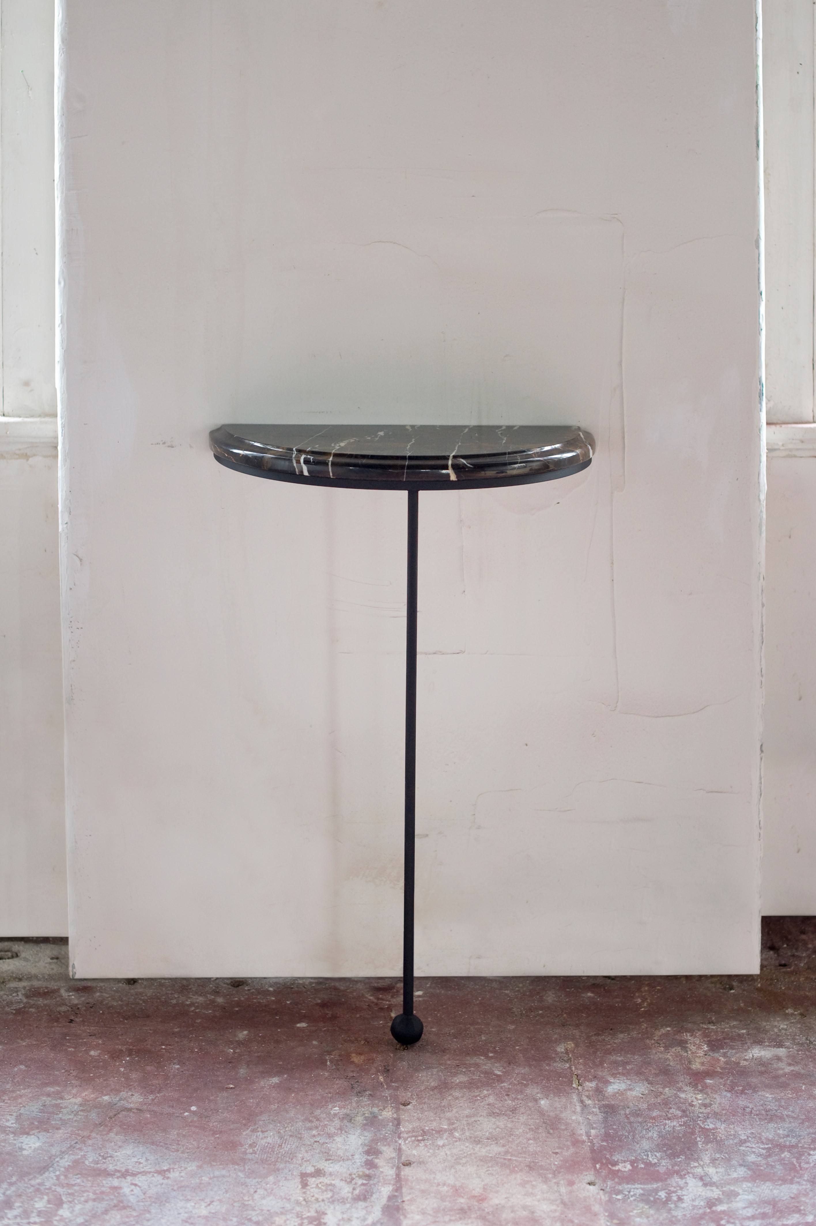 a black table with a marble top in a room