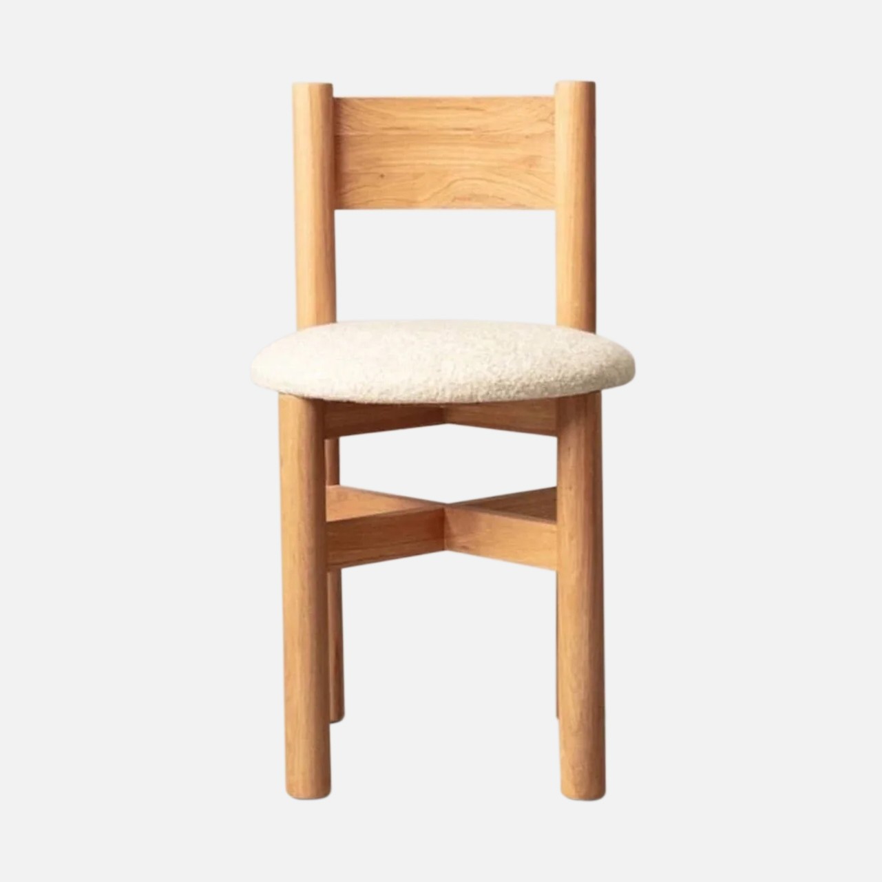 a wooden chair with a white cushion on it
