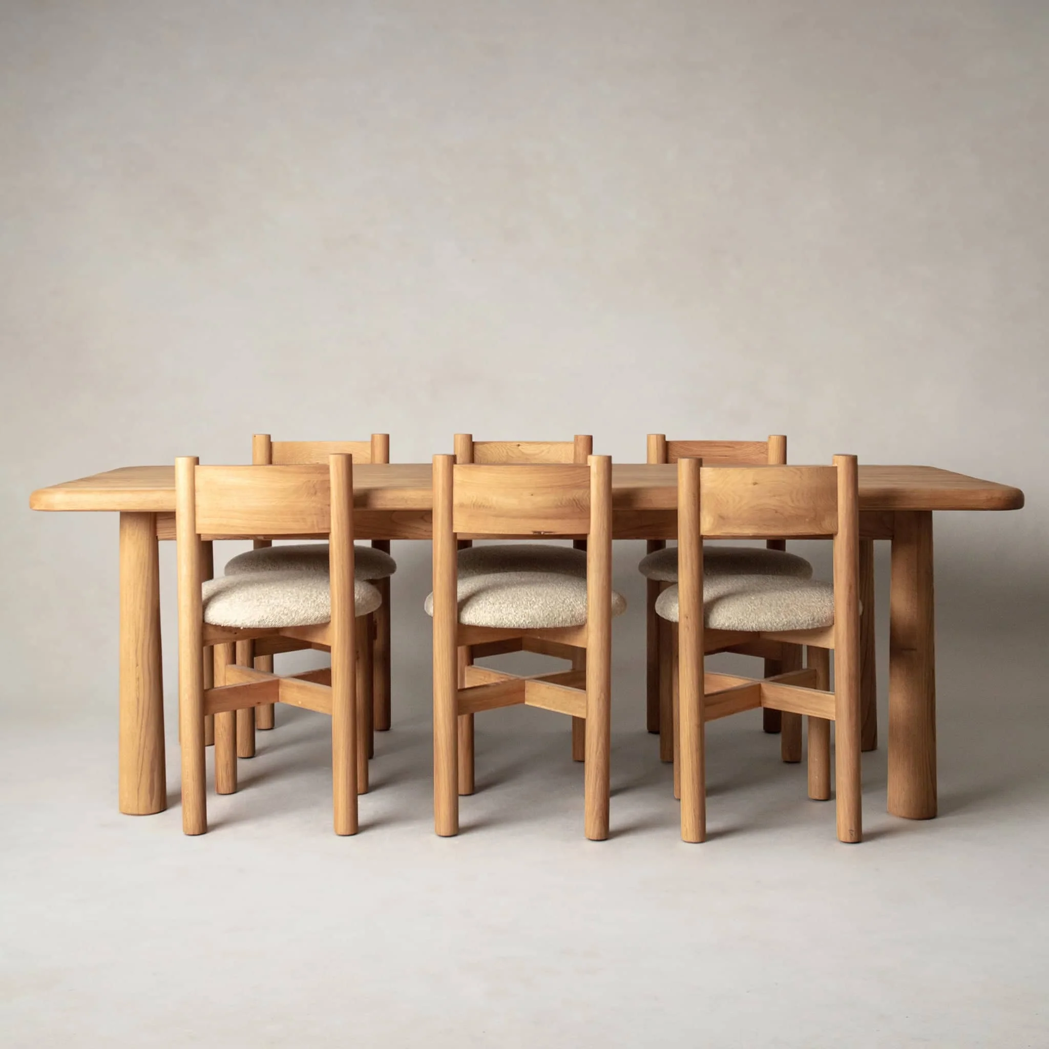a group of wooden chairs sitting around a wooden table