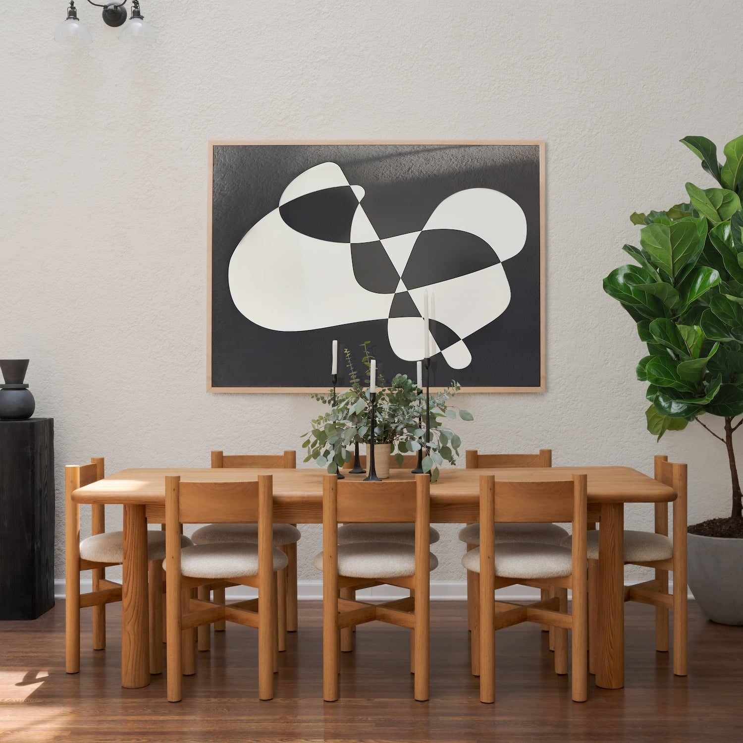 a dining room with a painting on the wall