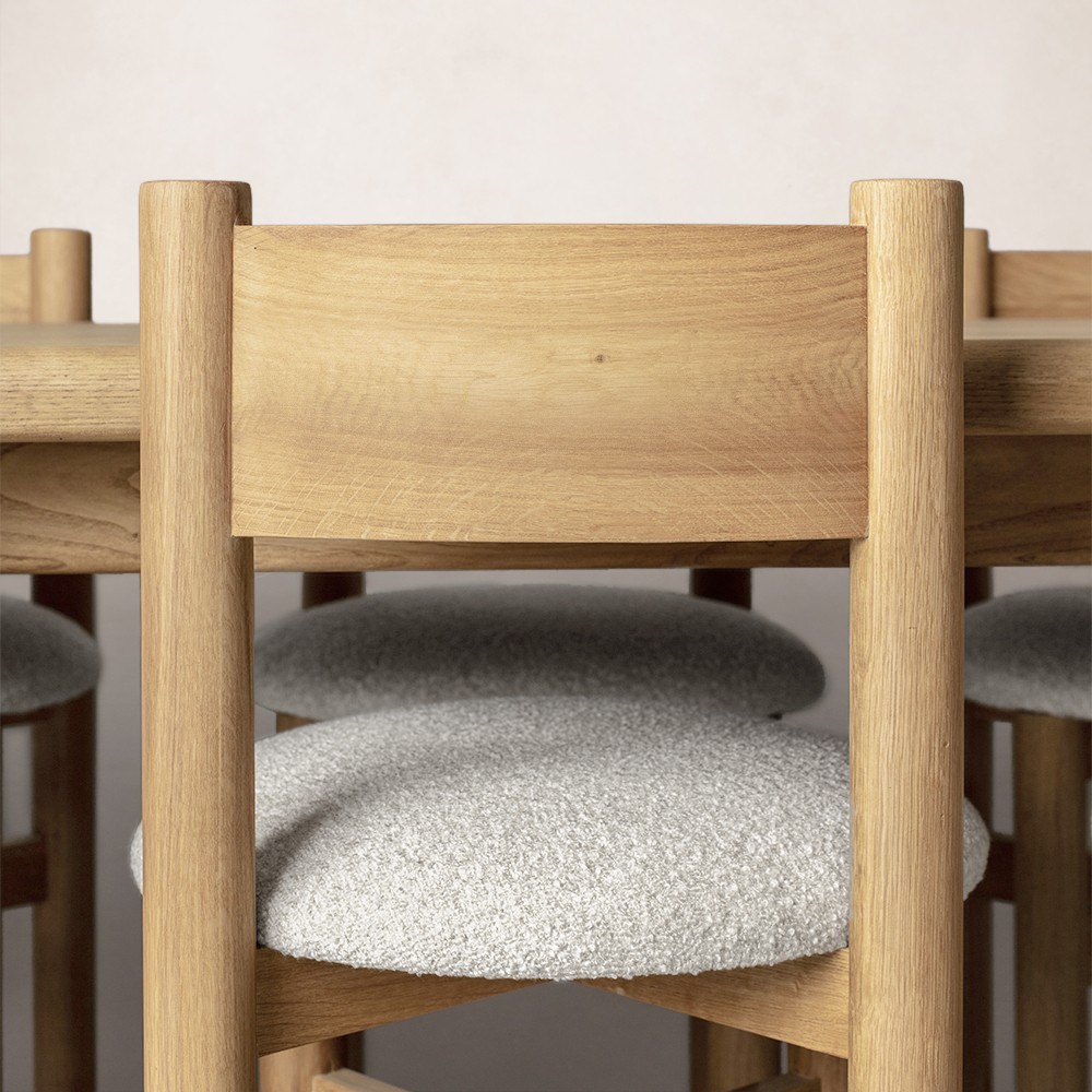 a close up of a wooden table with chairs