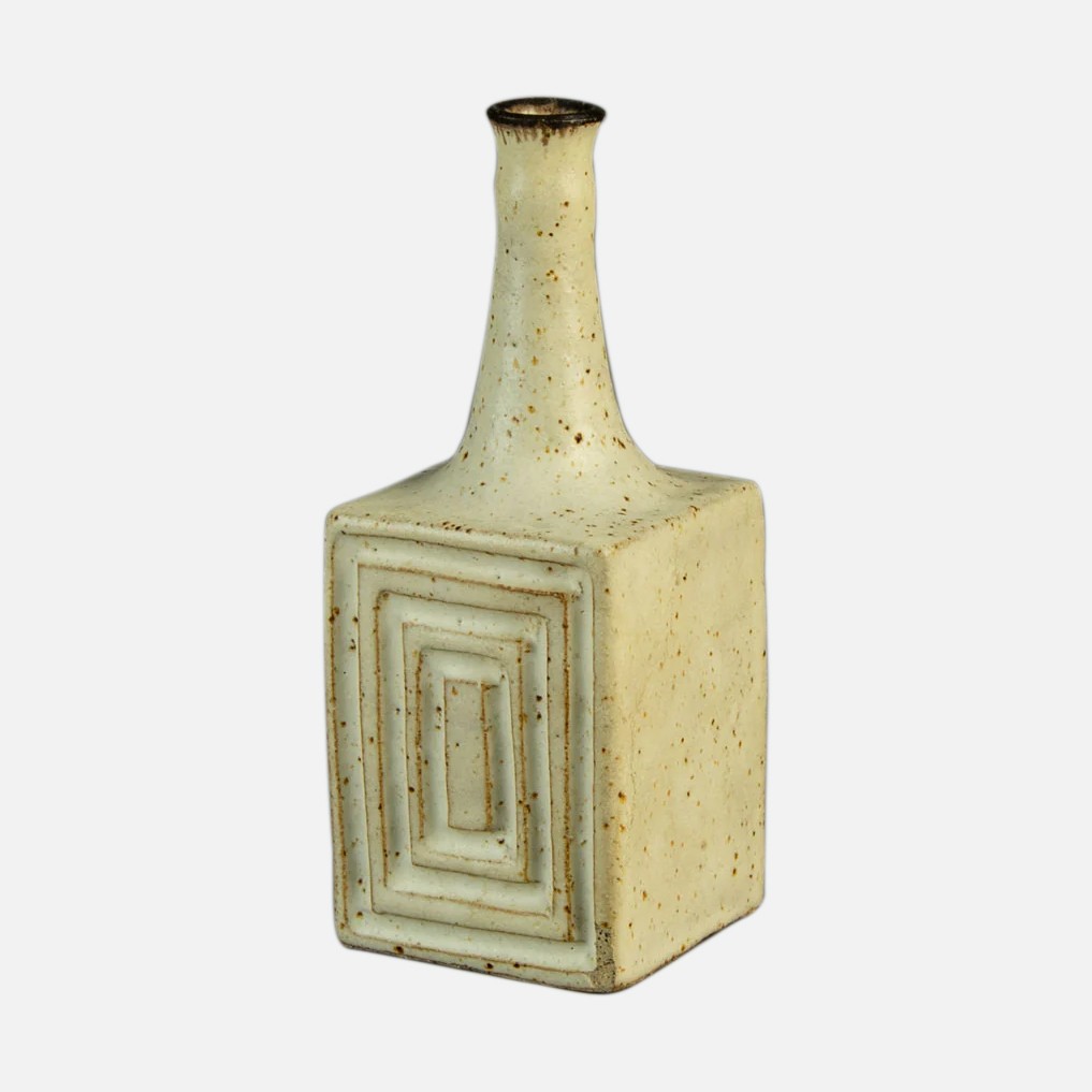 a white vase with a square design on it
