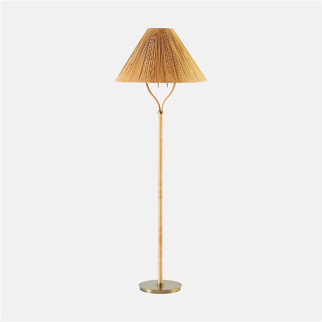 a wooden floor lamp with a beige shade