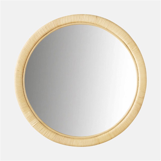 a round mirror on a white wall
