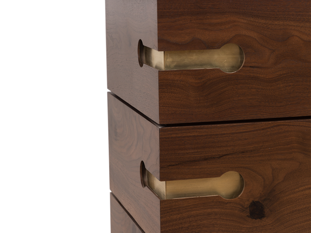 a close up of a wooden drawer with brass handles
