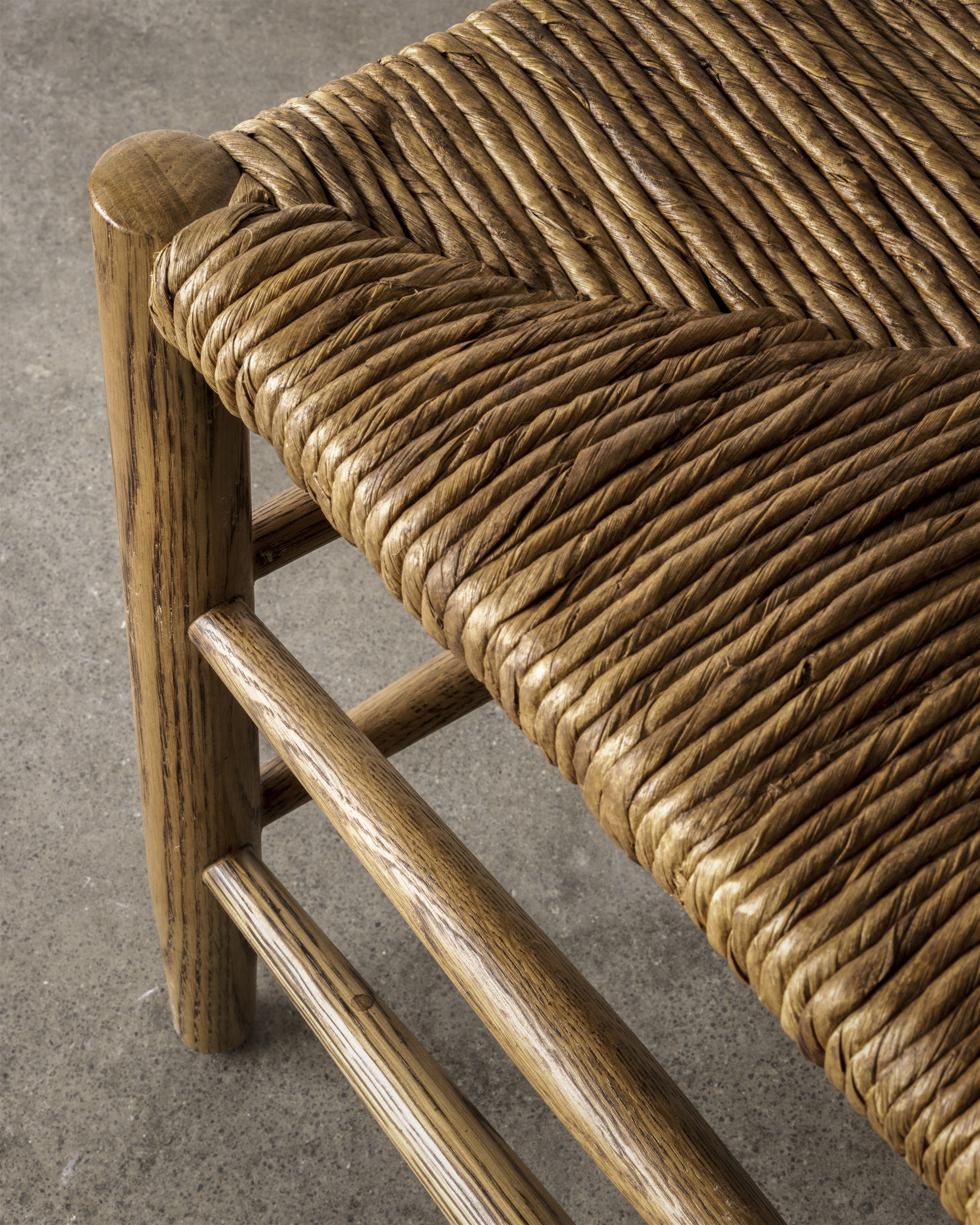 a close up of a wooden bench made of wicker