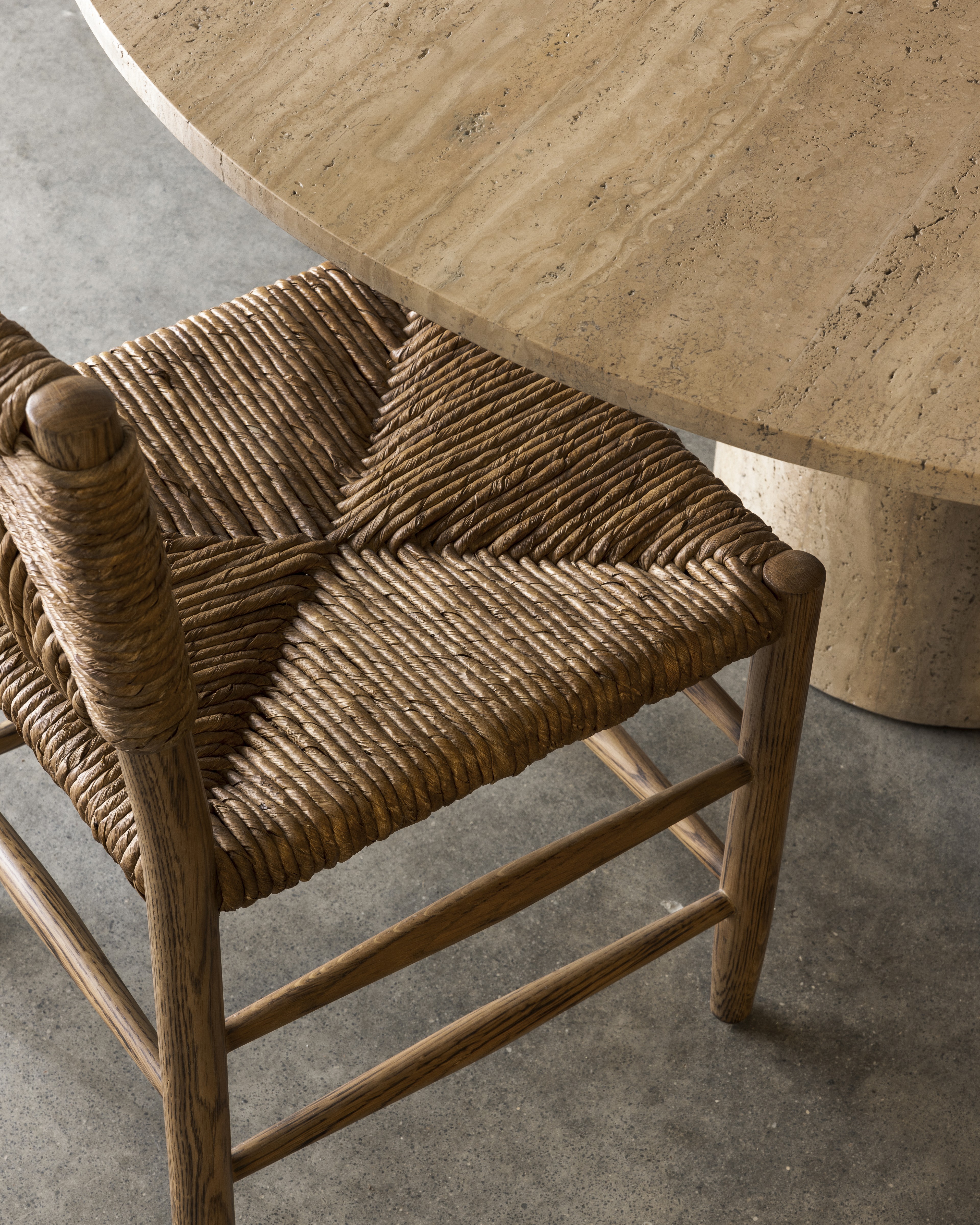 a wicker chair sitting in front of a wooden table