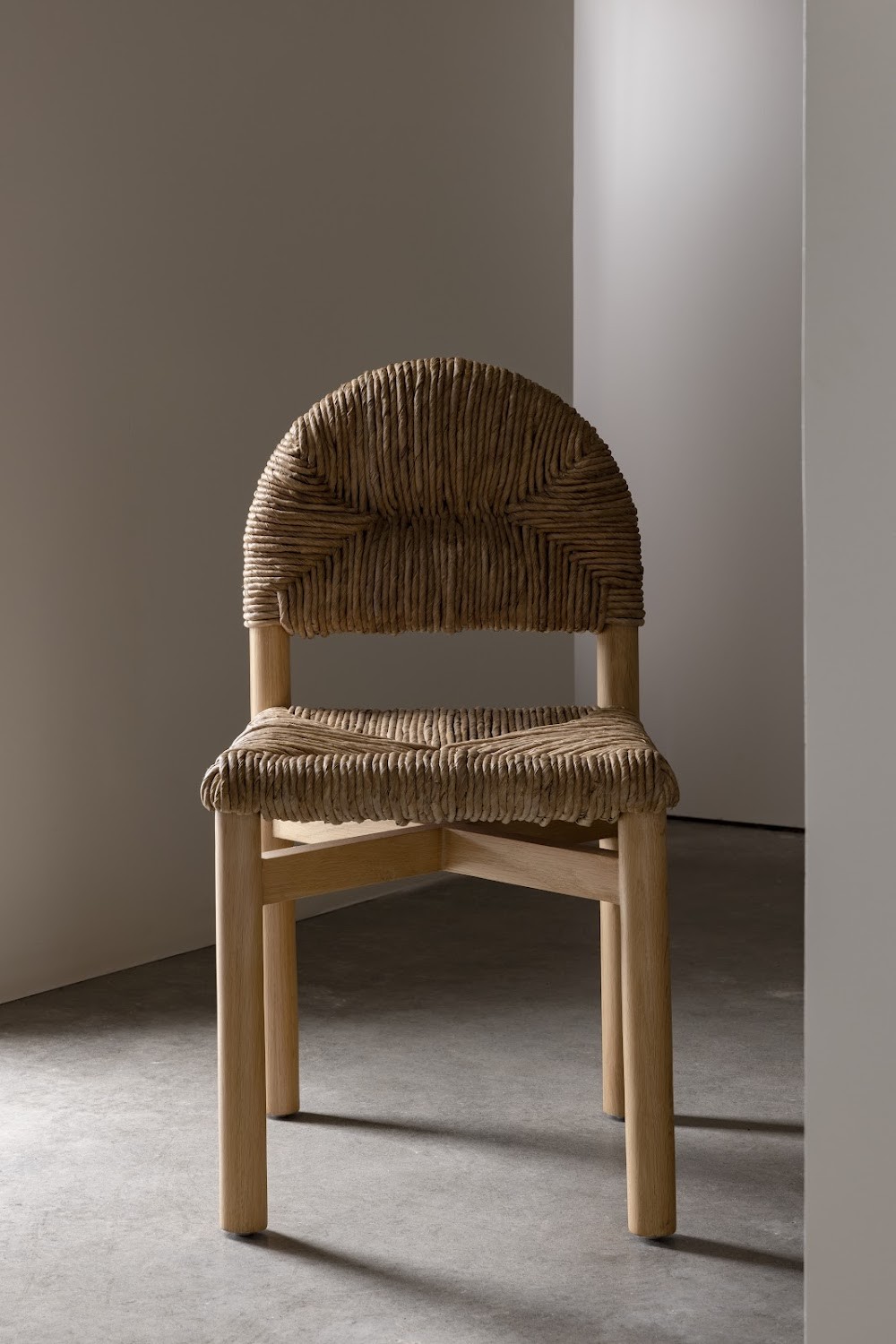 a chair made out of wicker sitting in a room