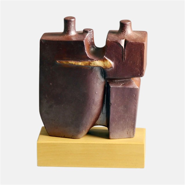 a wooden sculpture of a man's torso on a wooden stand