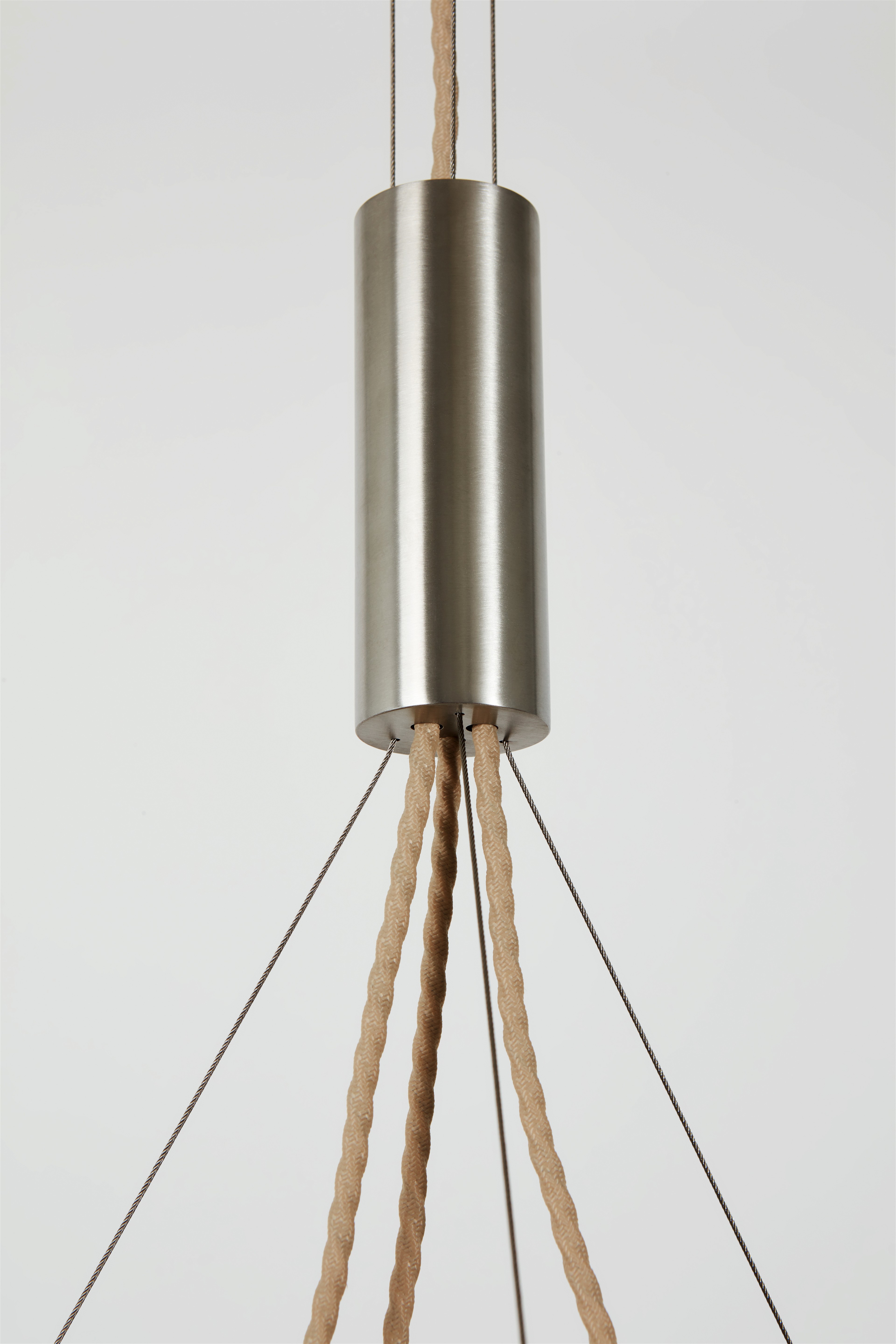 a metal light hanging from a ceiling fixture