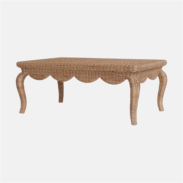 a wicker table with scalloped legs
