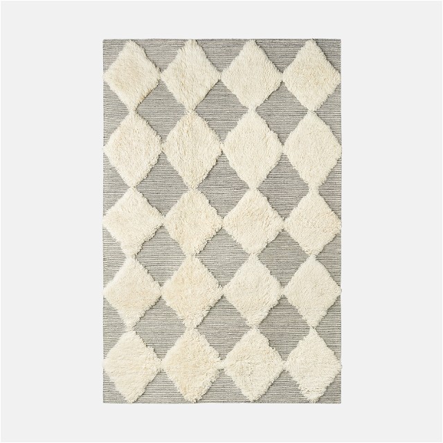 a gray and white rug with squares on it