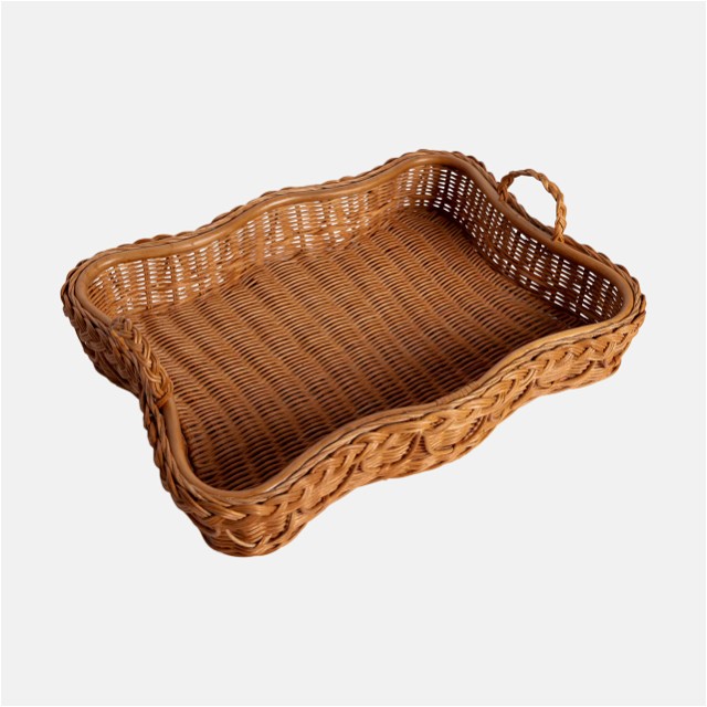 a wicker tray with handles on a white background