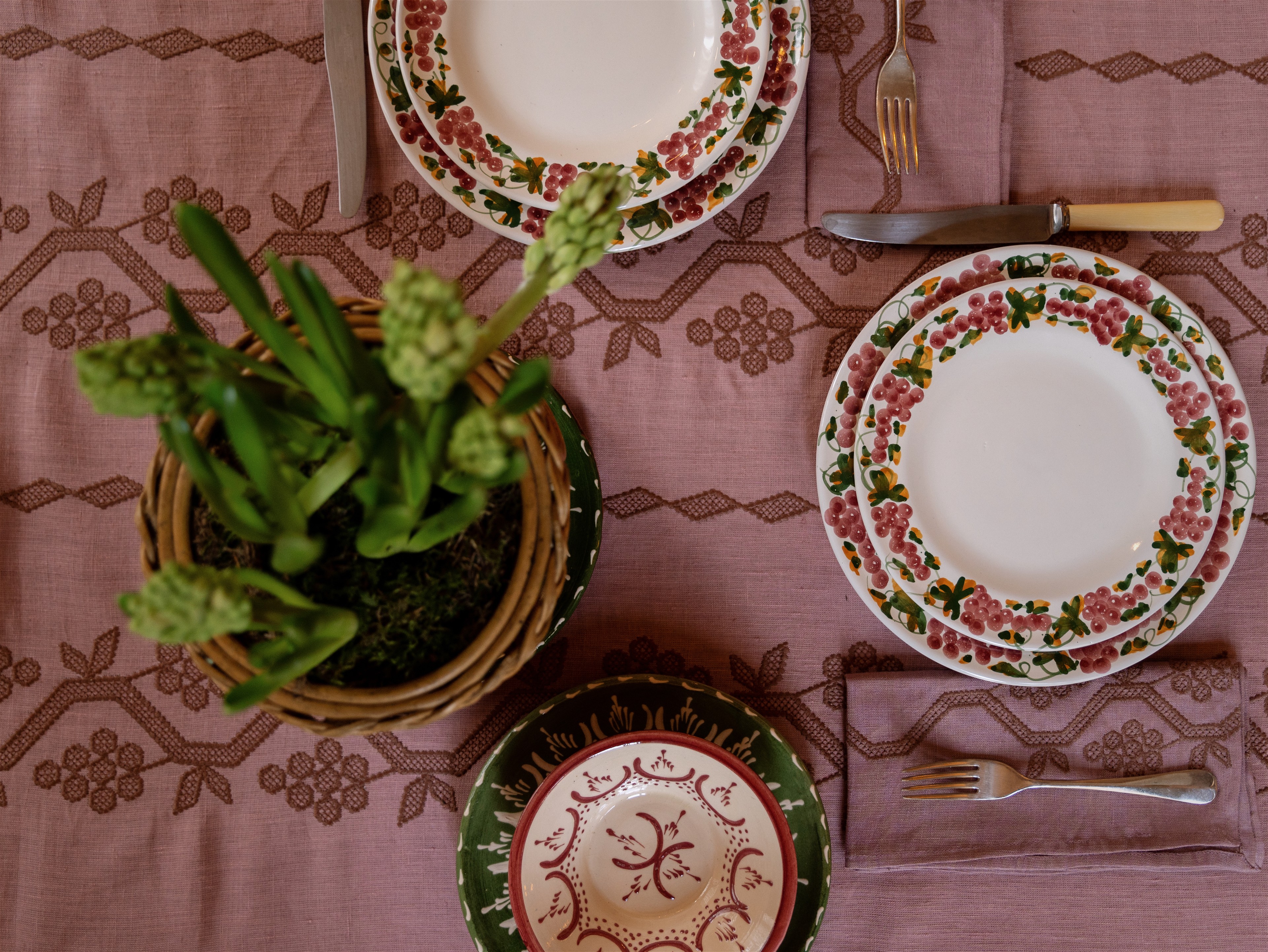 a table topped with plates and a potted plant