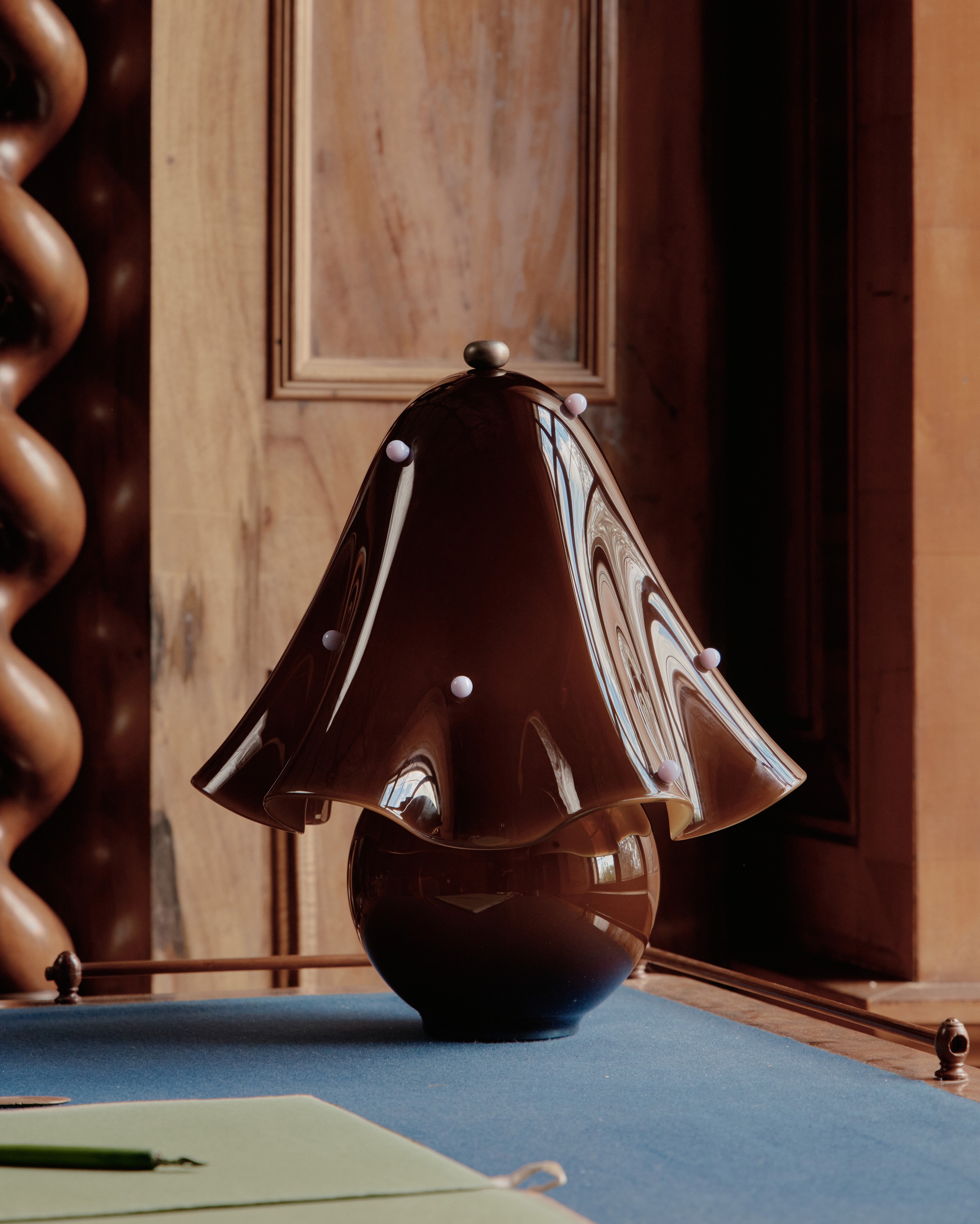 a brown lamp sitting on top of a blue table