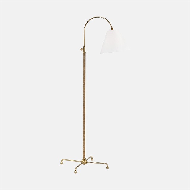 a floor lamp with a white shade on it