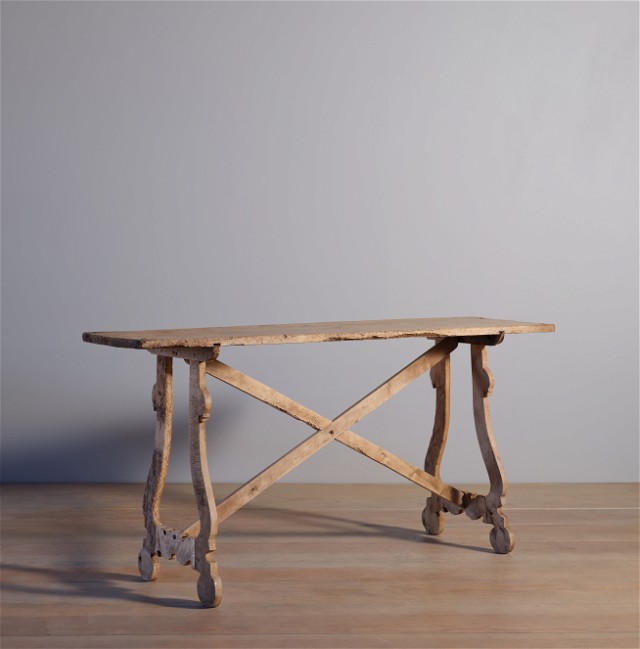 a wooden table sitting on top of a wooden floor